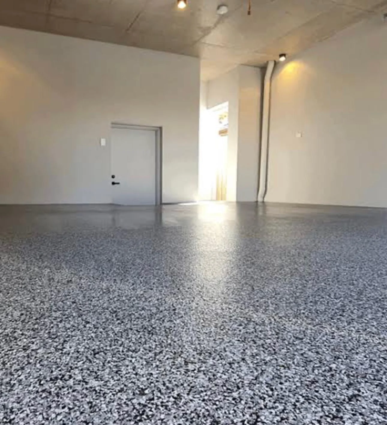 Grey and white flecked epoxy floor in a garage