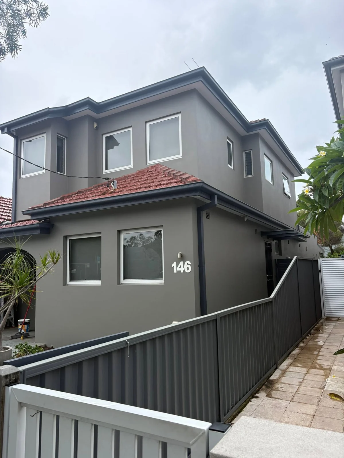 Two-storey home painted grey with dark trims