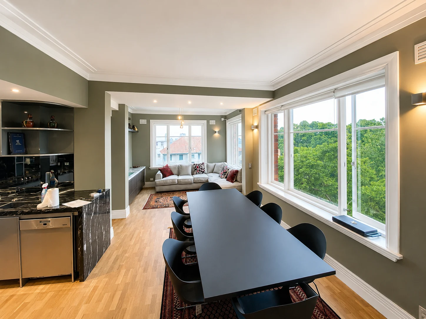 Olive painted dining and living room with white window frames