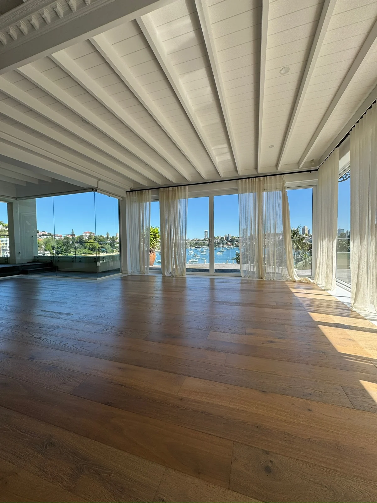 White painted timber ceiling and walls in a bright home overlooking the water